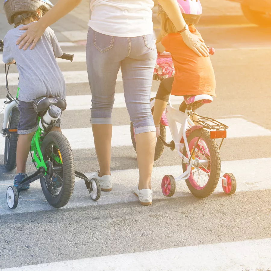 Parent supervises children at a crossing