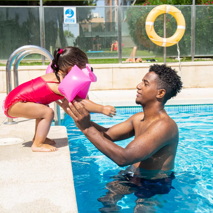 Father teaching child to swim