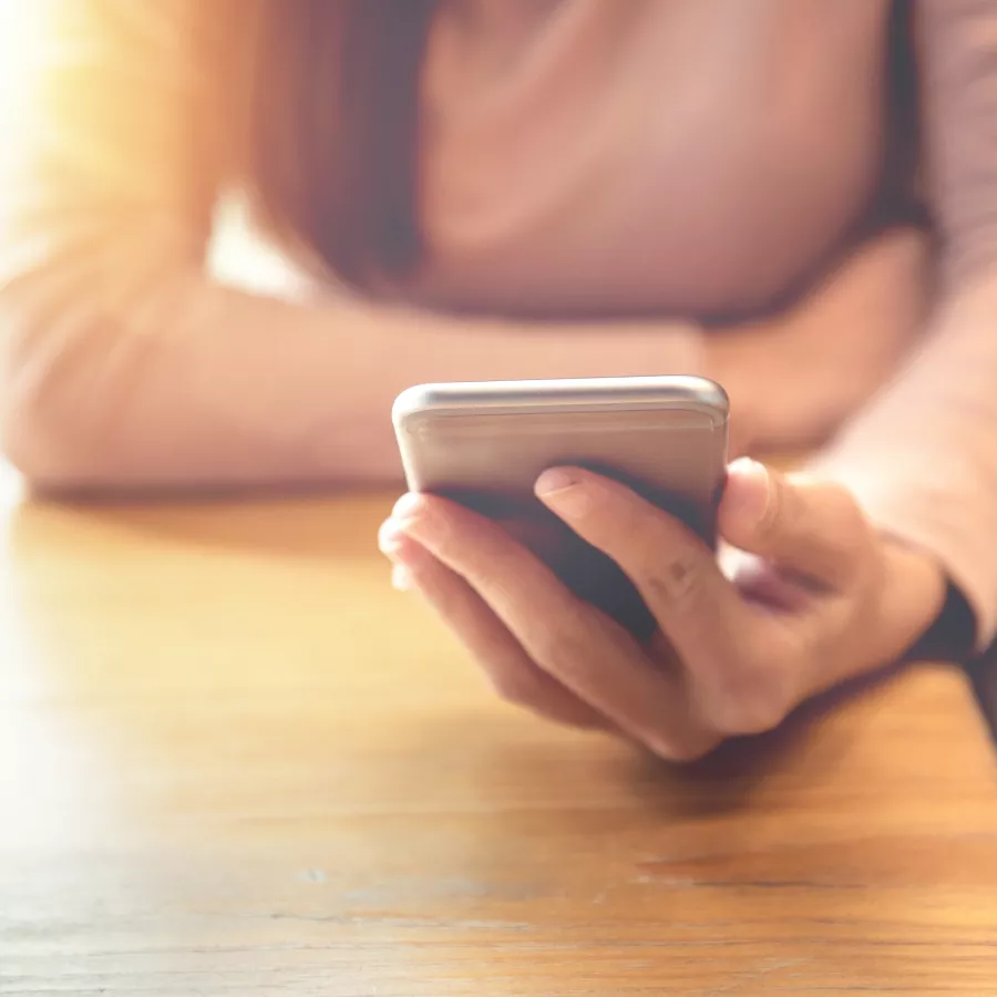 woman holds a smartphone